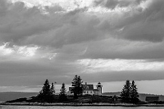 Rustic Pumpkin Island Lighthouse Under Breaking Clouds